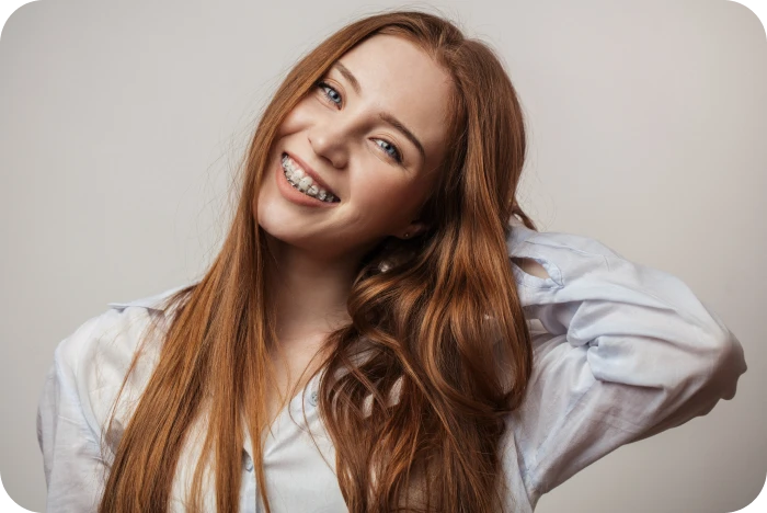 Patiente souriante portant un appareil orthodontique multi-attaches